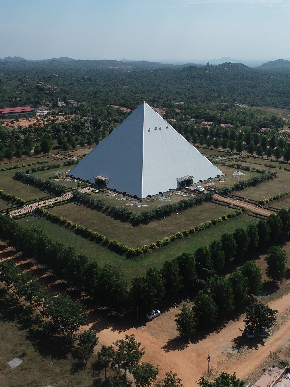 A meditation pyramid surrounded by gardens